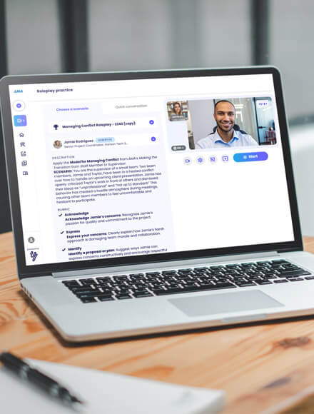 Laptop screen showing AMA Skill Coach roleplay session with virtual communication skills training interface