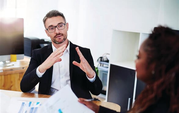 Business professional explaining ideas during office meeting with colleague