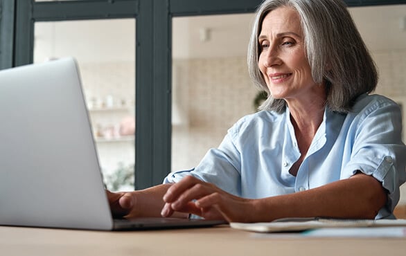 Professional woman working on a computer to create an AI Launch Pad