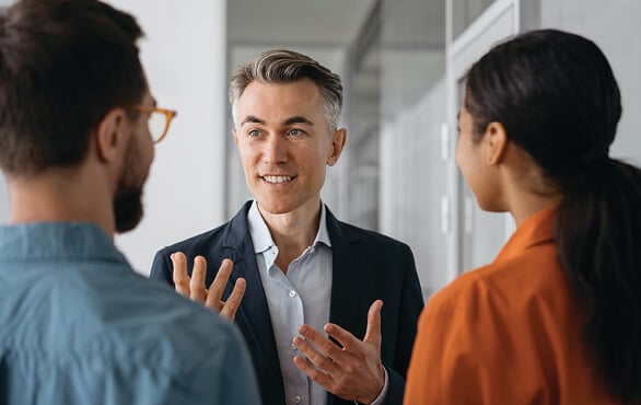 New supervisor speaking with team members while developing core managerial skills