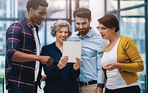 Diverse group of coworkers celebrating teamwork while building leadership influence skills