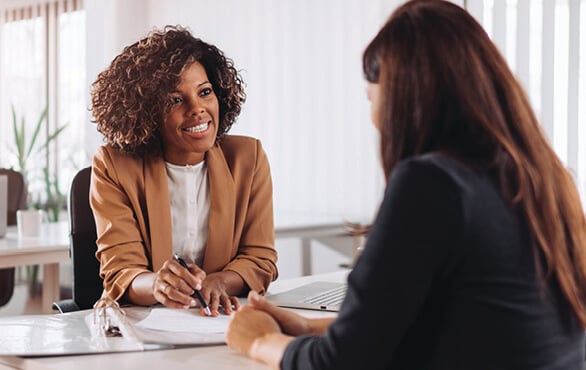 Woman coaching another professional to build confident workplace communication skills