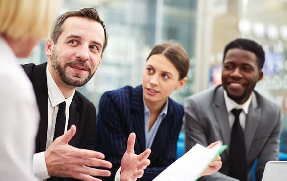 Business leaders discussing the impact of trust-centered leadership in a professional setting.