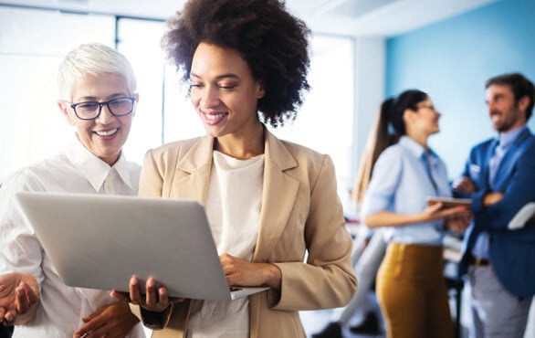 Business professionals learning about AI business essentials through an online course.