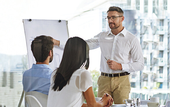 Manager leading a team meeting as part of new manager leadership and management skills training