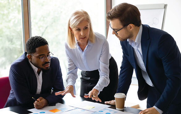 Team collaborating in an office meeting focused on productivity, decision-making, and leadership skills