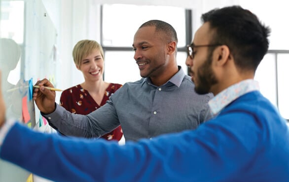 Project manager guiding a team through project planning during professional development training
