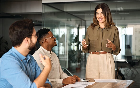 New manager greeting a colleague during a professional leadership and management skills development program