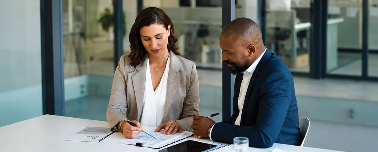 Manager providing employee development support and guidance during a workplace coaching conversation.