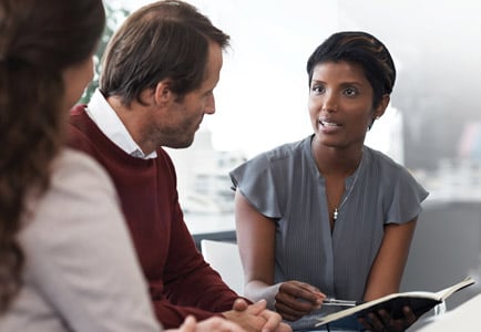 Professional team discussion in office meeting focused on critical thinking and problem-solving skills