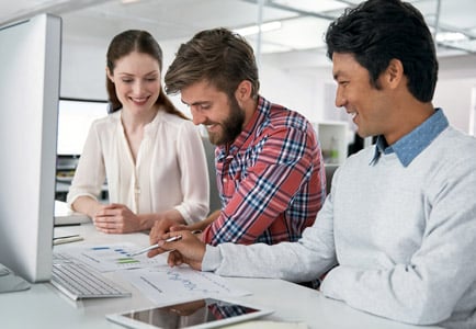 Business professionals collaborating with data and technology, applying AI and critical thinking for better decision-making