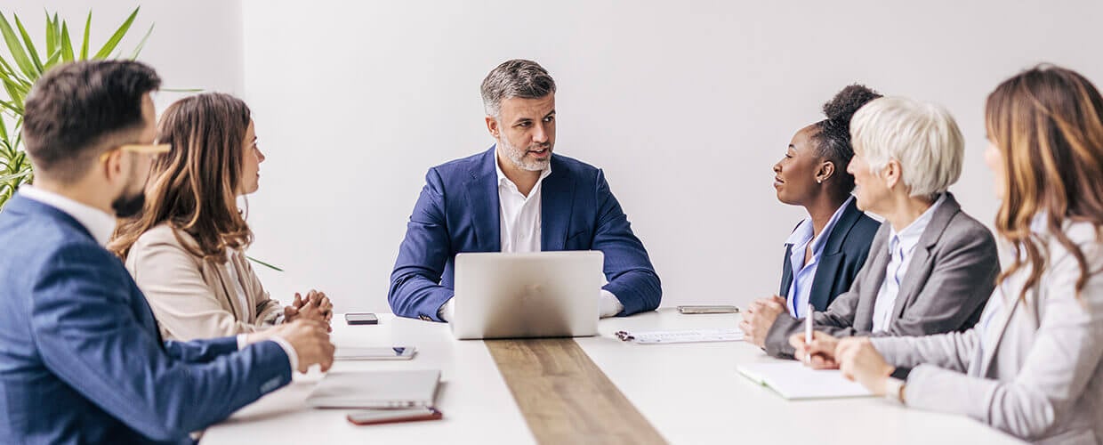 AI training meeting with manager leading team discussion on workforce development