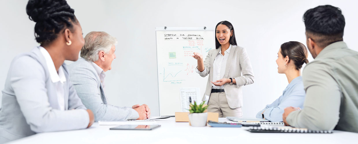 Business professional presenting ideas to a diverse group of colleagues during a workplace meeting, illustrating talent recognition, leadership and employee development.