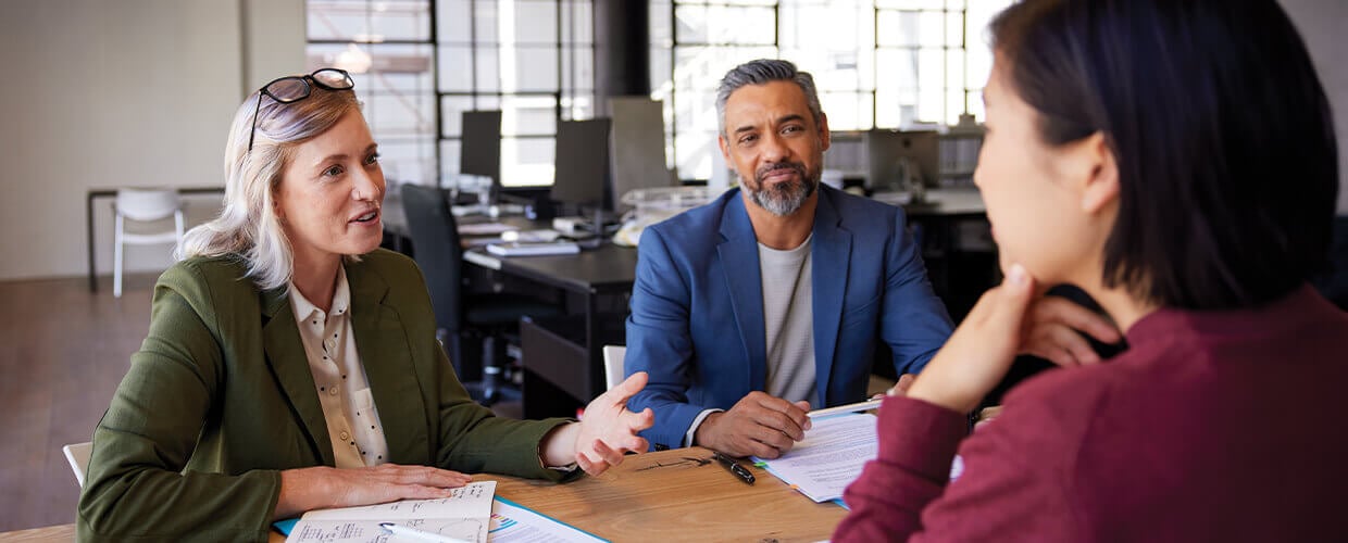 Team members in a meeting discussing strategy, leadership, and workforce development.
